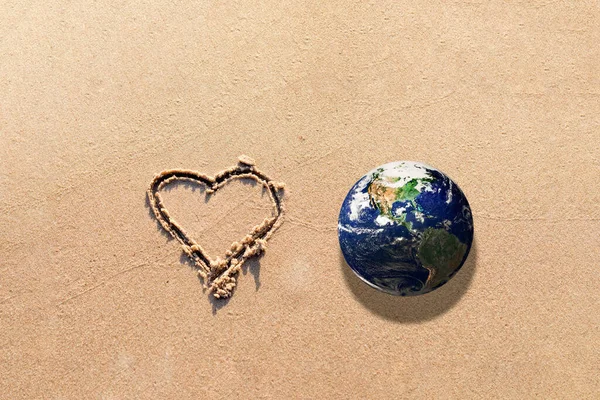 World earth globe,Heart Drawn in the Sand on a Beach.Love and take care of our Natural world with our hearts concept.Elements of this image furnished by NASA.Copy space.