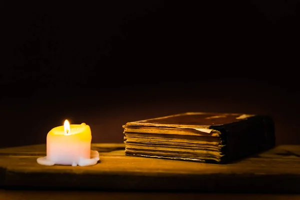Religious concept.Bible and candle on a old wooden table.Beautiful gold background.Beautiful,pleasant Religion concept.Copy space.