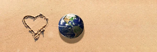 World earth globe,Heart Drawn in the Sand on a Beach.Love and take care of our Natural world with our hearts concept.Elements of this image furnished by NASA.Banner,advertisement.Copy space.