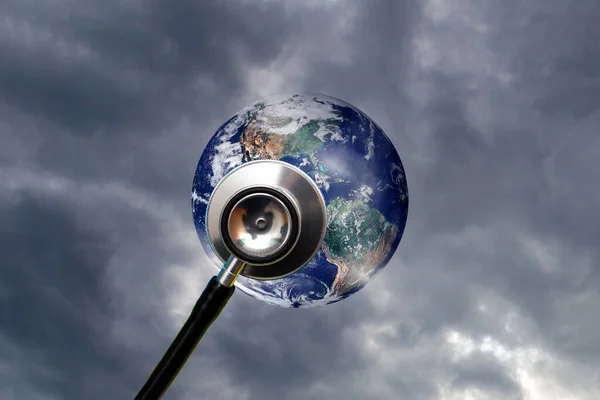 Globe health and stethoscope diagnose on dramatic sky cloudy background.Concept for global medicine.Isolated on blue.Elements of this image furnished by NASA.