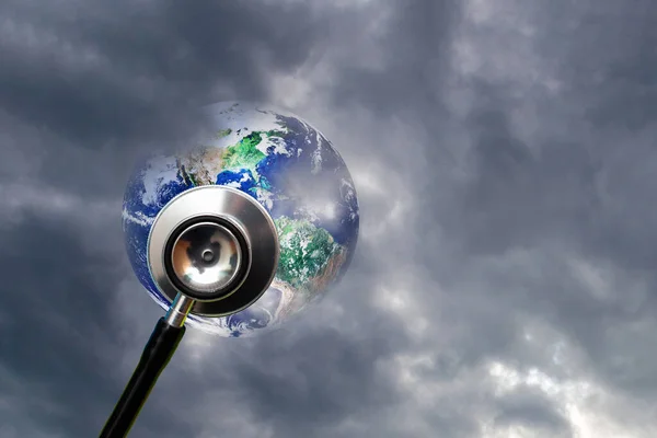 Globe health and stethoscope diagnose on dramatic sky cloudy background.Concept for global medicine.Isolated on blue.Elements of this image furnished by NASA.Copy space.