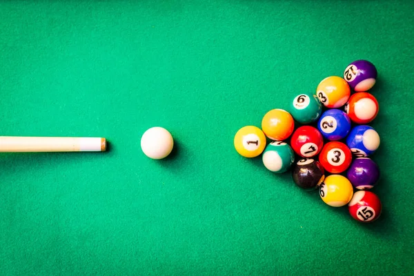 stock image Billiard balls on the green table with billiard cue, Snooker,Pool game.Cue aim billiard snooker pyramid on green table.Top view.