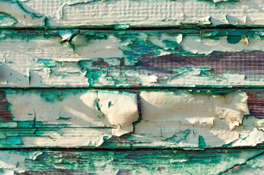 Renk soyma ahşap dokusu. Arka plan olarak eskimiş ahşap duvarlar, çizikler ve detaylarla kaplı grunge doku deseni. Boya kabuğu soyulmuş eski tahta. Çatlak boya dokusu..