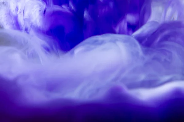 Ink water burst. Fantasy clouds.Fluorescent pearl blue purple color light fluid drop swirl on bright gradient abstract art copy space.Purple creative abstract blurred background shot.