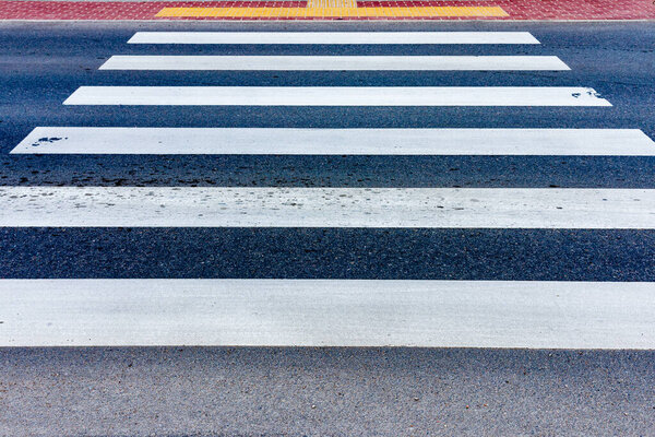 Crosswalk on the road for safety when people walking cross the street.Zebra crossing on outdoor road.Outdoors shot.Summer day.