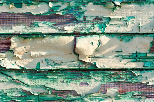 Grunge texture pattern with scratches and paint peel off details.Color Peel wood texture.old weathered wooden planks wall as background.old plank rotted with paint peeling off.cracked paint texture.