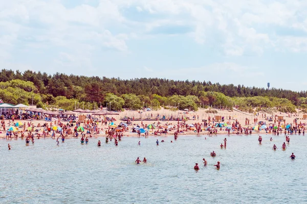 stock image Crowdy beach sunny day by the sea, crowds of people.Blue sky hot summer day.Palanga-Lithuania,June 27-2020.