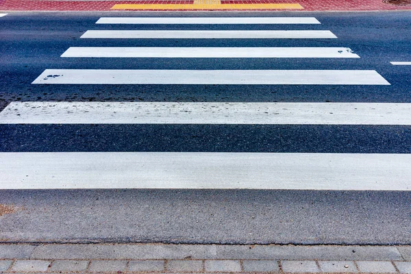 Zebra crossing on outdoor road.crosswalk on the road for safety when people walking cross the street.Outdoors shot.Summer day.