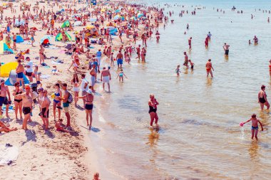 Deniz kenarındaki kalabalık plaj güneşli bir gün, kalabalık. Mavi gökyüzü sıcak yaz günü. Palanga-Litvanya, 27-2020.