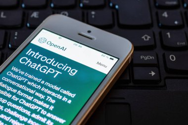 Bilgisayar klavyesinde ChatGPT web sitesi olan akıllı telefon. OpenAI.Telsiai.Litvanya.04-27-2023.