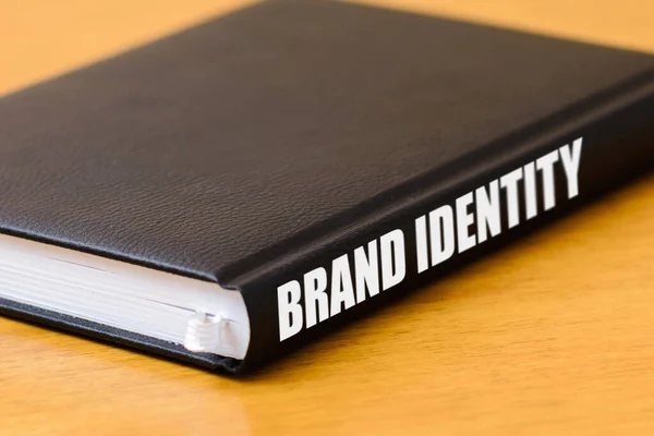 Book with brand identity guidelines lie on the table.