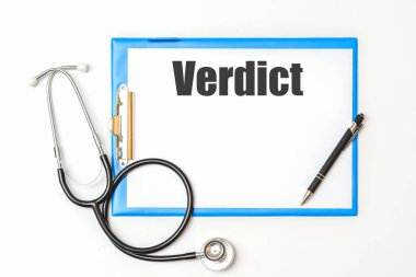 VerDICT yazıtları. Bir not defterine neyin önemli olduğunu hatırlatmak için. Steteskop ve kalemle birlikte. Sağlık hizmeti kavramı..