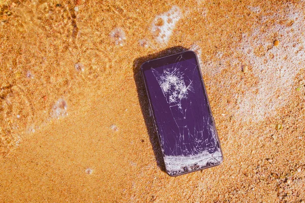 度假问题 智能手机出故障了 智能手机在海滩上掉落和撞毁 手机在沙滩海岸受损 随时可用 — 图库照片