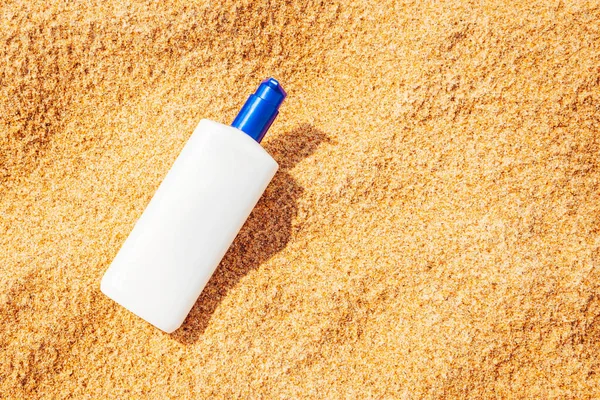 Sunscreen cream bottle on the beach.Design cosmetic product template mockup for sunblock cosmetics. Sunscreen cream on a summer beach.Copy space.