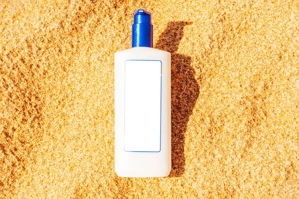 Sunscreen cream bottle on the beach.Design cosmetic product template mockup for sunblock cosmetics. Sunscreen cream on a summer beach.
