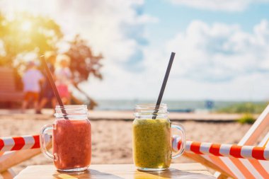 Tropikal sahilde iki taze meyve suyu. Lüks tropik yaz plajlarında kokteyller. Gün batımı ya da gün doğumu..