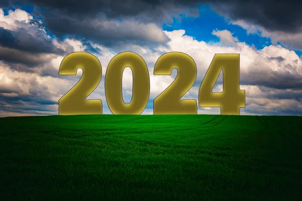 New Year 2024 is change concept.Green meadow with blue sky and clouds background.2024 change years inscription on the top.New year hopes, business plans and success steps.New Year concept.