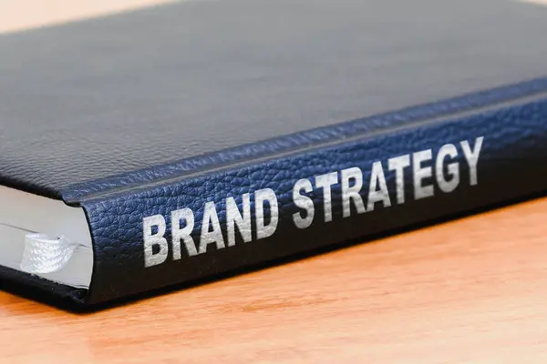 Brand strategy business black book on the office wooden table.Closeup,selective focus.