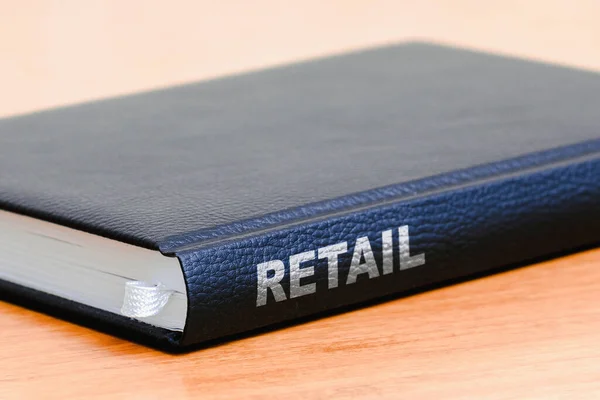 Retail business black book on the office wooden table.Closeup,selective focus.