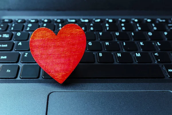 Concept online dating.Online date. Heart on laptop computer keyboard.Closeup.