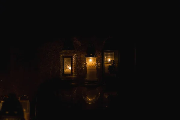 Candles Burning at Night.White Candles Burning in the Dark with lights glow.Focus on candles.