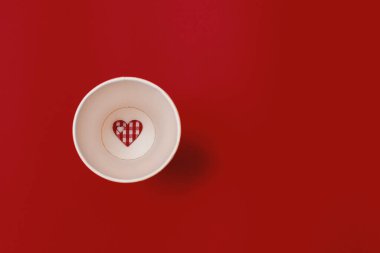 valentine's day red heart,garbage can red surface, top view,copy space.