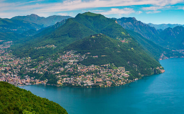 Spectacular panoramic view over the city of Lugano, the Lugano Lake and Swiss Alps, visible from Monte San Salvatore observation terrace, canton of Ticino, Switzerland.
