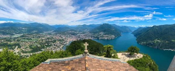 The Church of San Salvatore with its lookout point offering stunning 360 panoramic views of Lake Lugano, the city of Lugano and the magnificent mountain ranges of the Swiss and Savoy Alps, canton of Ticino, Switzerland.