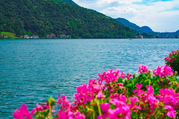 stock image Amazing panoramic view of Lake Lugano and the green Swiss Alps in the background on a sunny summer day. Canton of Ticino, Switzerland.