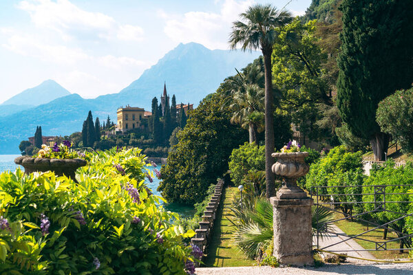 Stunning panoramic view of the historic luxury Villa Monastero with gorgeous lakefront gardens and spectacular Lake Como views in Varenna, Province of Lecco, Italy.