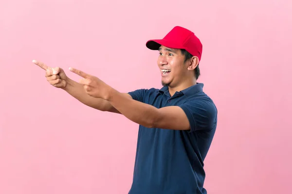 Happy Courier Man Pointing Away Copy Space Advertisement Isolated Pink — Stock Photo, Image