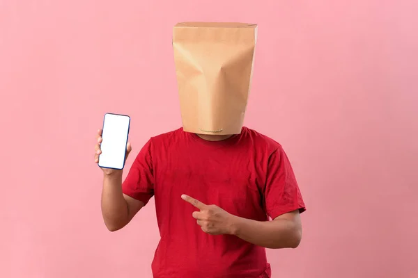Concept Portrait Asian Man Head Covered Paper Bag Pointing Phone — Stock Photo, Image