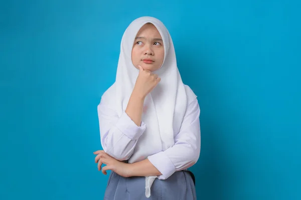 Thoughtful Indonesian Student Thinking Blue Studio Background College Education Study — Stok fotoğraf