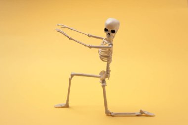 Renkli arka planda insan iskeletinin komik duruşu