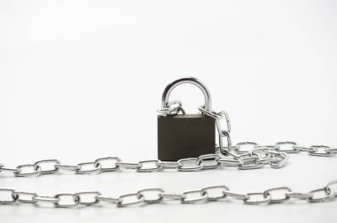 A metal chain with locked padlock on the white background symbolising closed access