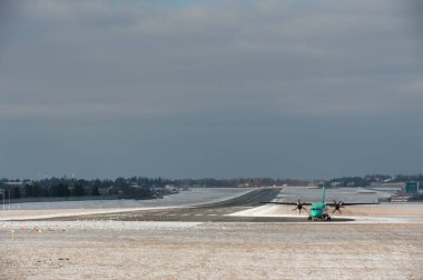 Lviv, Ukraine - 01.12.2022: Windrose ATR-72 moving at the runway of Lviv International Airport. Side view clipart