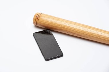 A modern phone with a broken screen and wooden bat on a white background clipart