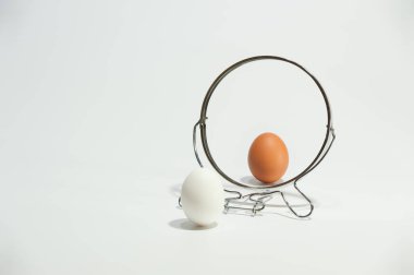 White and brown eggs reflected in the mirror on the white background. clipart