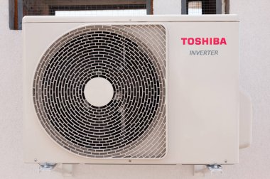 Lviv, Ukraine - 09.10.2021: Toshiba air conditioner outdoor unit installed on the wall clipart