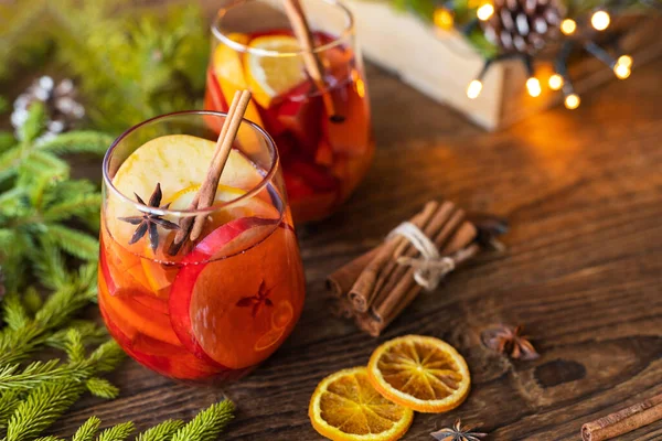 stock image Glasses of hot freshly brewed mulled wine with pieces of fresh fruit. Traditional winter drink.