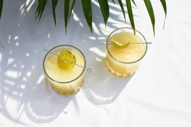 Refreshing melon smoothie with ice and lime in the sun. Summer cooling drinks