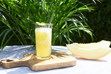 Refreshing iced melon cocktail or smoothie garnished with a sprig of mint. The concept of refreshing summer drinks. Detox. 