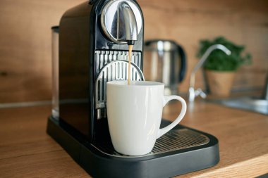 Kahve yaparken kahve yapan bir kapsül kahve makinesinin yakın çekimi..