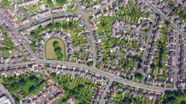 Straight down aerial footage of the British town of Halton in Leeds West Yorkshire showing typical suburban housing estates with rows of houses, taken on a bright sunny day using a drone.