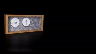 A wooden calendar block showing the date April 17th with a mans hand putting on and taking off the metal discs with the date and month on them, filmed in 8k quality.