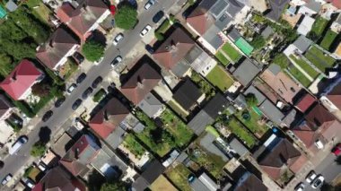 Straight down aerial drone footage of the the large suburb of Wembley  in north-west London in the UK, showing the residential streets and suburban houses on a hot sunny day in the summer time.