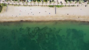 İspanya 'nın Balear Adaları' ndaki İbiza adasındaki Sant Antoni de Portmany kasabasında Playa de San Antonio olarak bilinen bir plajın havadan insansız hava aracı görüntüleri..