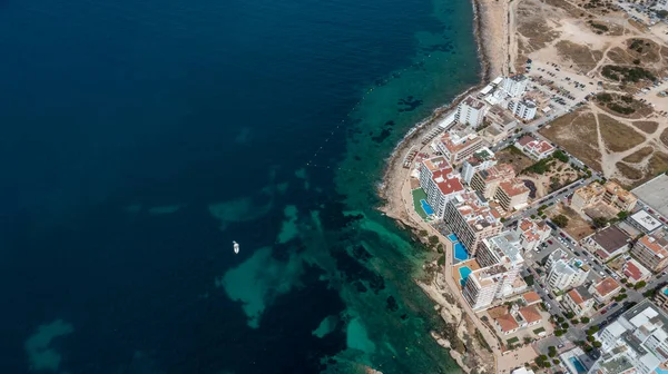 stock image Aerial drone photo of a beach in the town of Sant Antoni de Portmany on the island of Ibiza Balearic Islands Spain showing the ocean front and Cala Alto de Porta beach in the summer time.