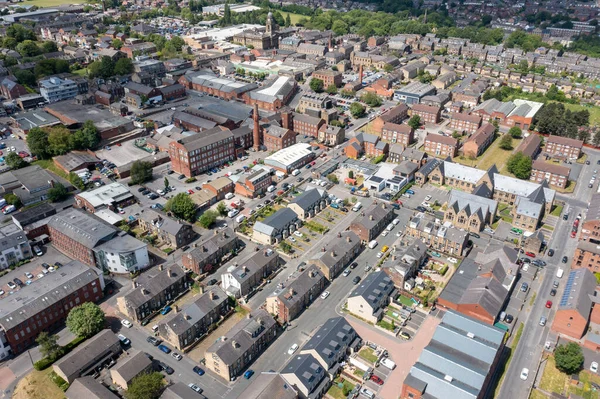 Aerial photo of the village of Morley in Leeds, West Yorkshire in the UK, showing an aerial drone view of the main street and historical old town hall and clock tower near the public park area.
