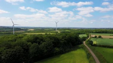 İngiltere, Barnsley Metropolitan Borough, Güney Yorkshire 'daki Great Houghton köyünün insansız hava aracı görüntüleri güneşli bir yaz gününde güzel bir köyde rüzgar türbinlerini gösteriyor..